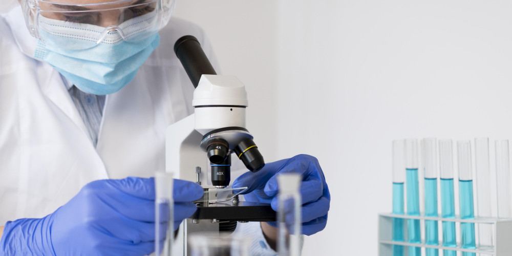 vrouw onderzoeker kijkt door microscoop